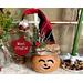 This is a whimsical Christmas elf made with a real dried gourd. This elf's name is Jingle. His face is carved into the round gourd shell. 